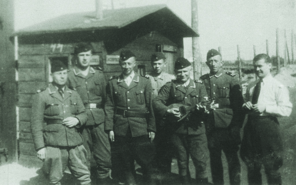 Many of those in the SS police force—like these men at the Belzec extermination camp, one playing a mandolin—were recruited from captured Soviet POWs. (U.S. Holocaust Memorial Museum, courtesy of Instytut Pamieci Narodowej)