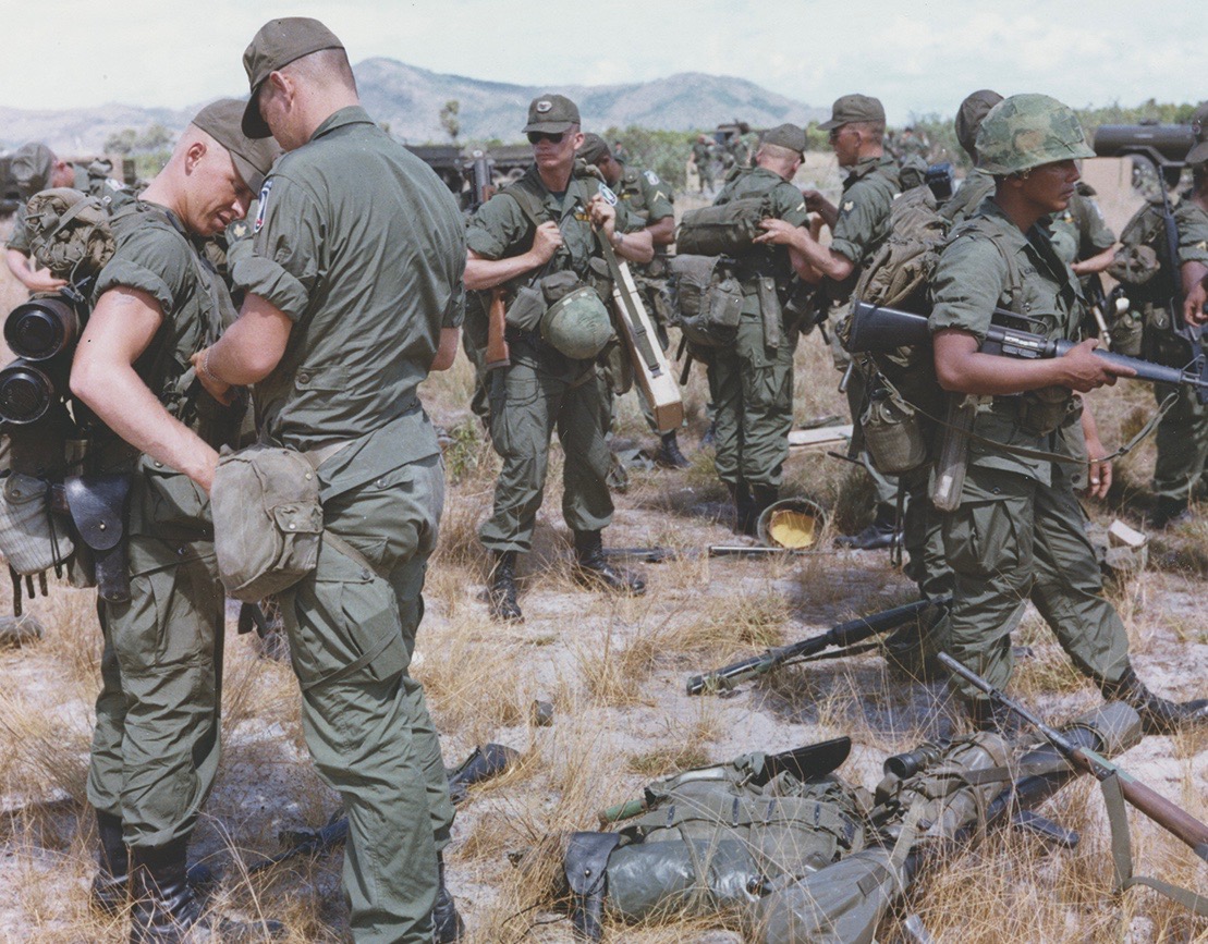 Before moving out, the troops check their weapons and equipment. (National Archives)