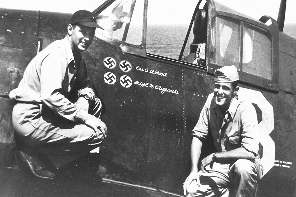 Ensign Alfred Wood (left) and Lt. (j.g.) Edward Olszewski of VOF-1 pose with a Hellcat in which each scored a double victory. (U.S. Navy via Barrett Tillman)