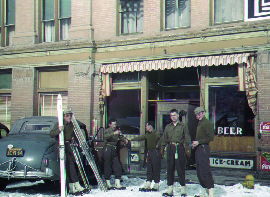 Fatigue-clad troopers lounge outside Aspen’s Jerome Hotel (above). While the division attracted top skiers, mountaineering (at Camp Hale in 1943, below) was arguably the more important skill. (The Denver Public Library, TMD-739)