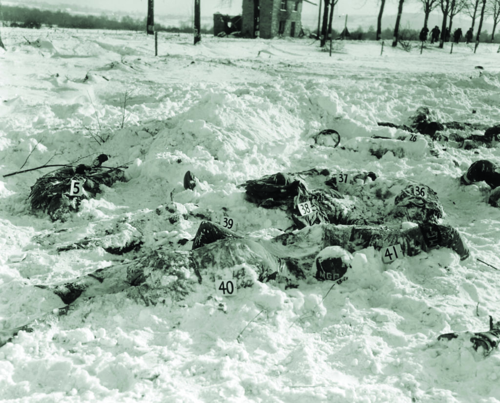 Army investigators numbered the bodies for identification; some showed signs the men had been tortured before their deaths. (U.S. Army/National Archives) 