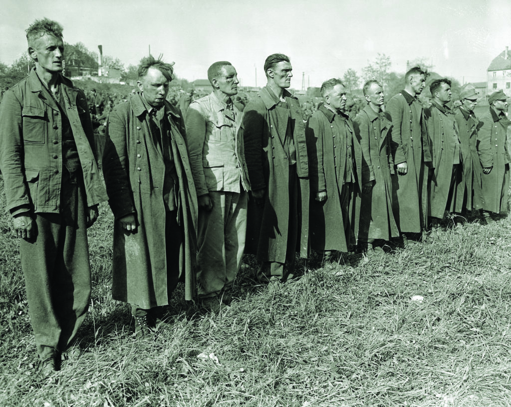 SS troops suspected of the massacre line up at a U.S. Army prison camp in Passau, Germany, just after the war. (Interfoto/Alamy Stock Photo)