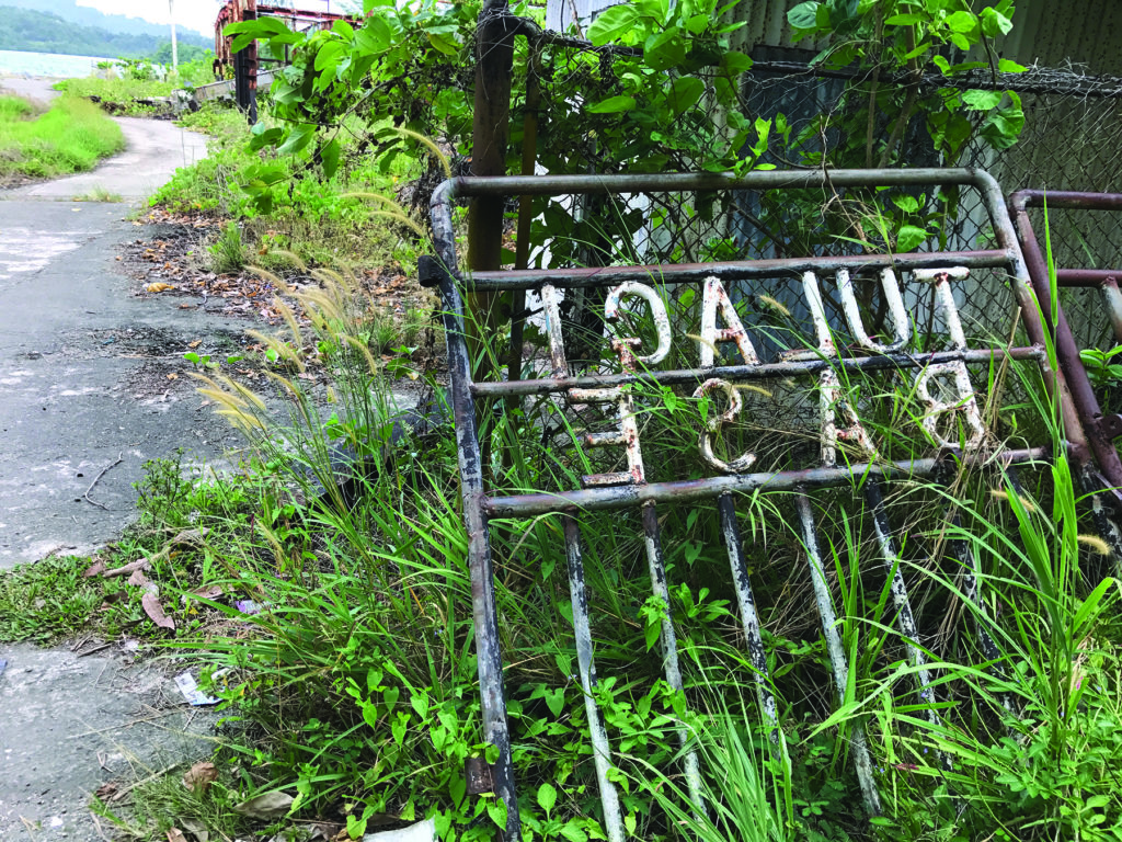 A neglected metal sign marks the former entrance to the American PT boat base on Tulagi’s northern coast. (William R. Coulson)