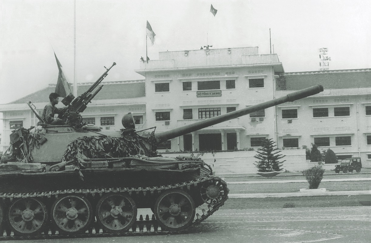 A North Vietnamese T-54 rolls past the South Vietnamese Joint General Staff building on April 30, 1975, the day of South Vietnam’s surrender. (ADN-Bildarchiv/Ullstein Bild via Getty Images)