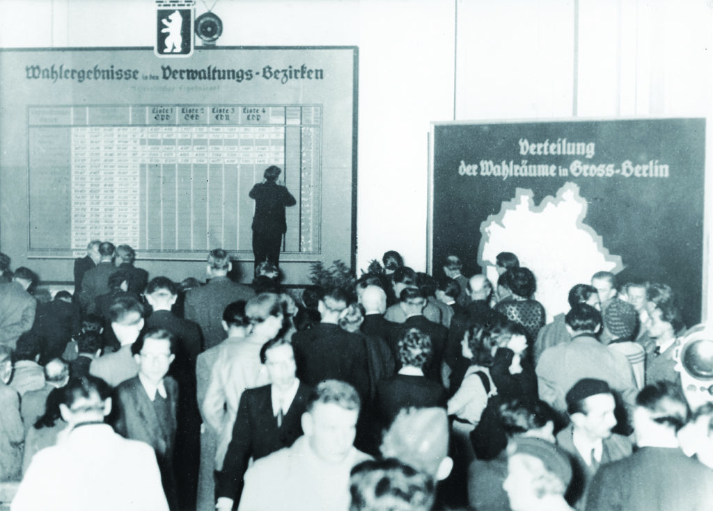 It soon became clear on election night (above) that the SED, the Soviets’ chosen party, was taking a drubbing. The declining relations between the Allied powers deteriorated further, culminating in the 1961 building of the Berlin Wall (below)—a literal divide between East and West. (Ullstein Bild via Getty Images)
