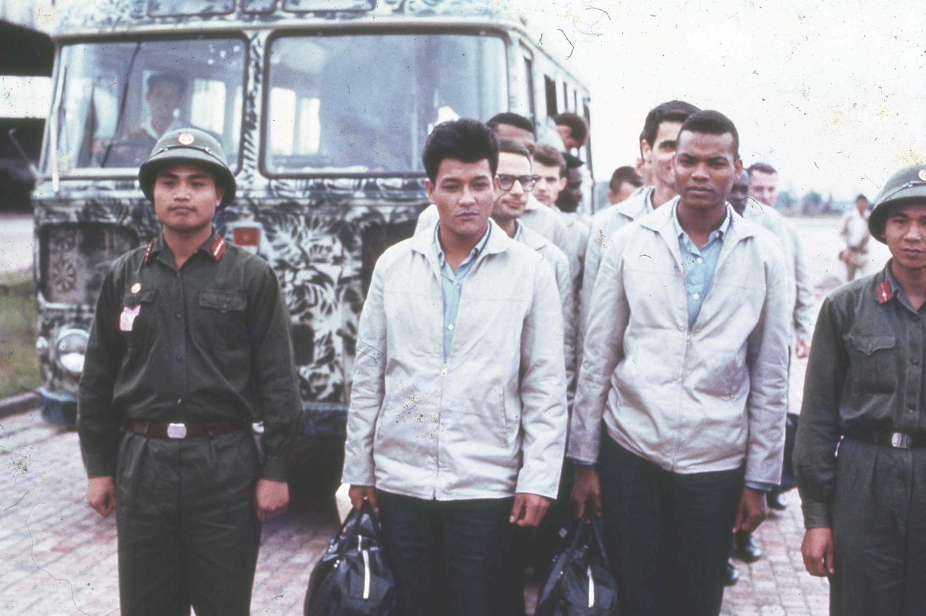 POWs freed in North Vietnam walk from the bus that transported them to Hanoi’s Gia Lam Airport, where they boarded a C-141 Starlifter for a flight to Clark Air Base in the Philippines. (U.S. Air Force)
