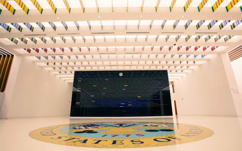 The museum’s lobby pays tribute to the Army’s 190 campaigns with illuminated glass panels, streamers, and a commemorative wall listing each U.S. Army battle. (National Museum of the United States Army, Scott Metzler)