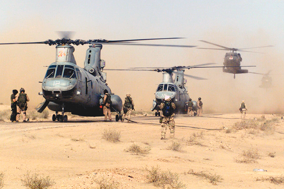 Two CH-46's Sea Knights and a UH-60 Blackhawk land on a road near Jalibah airstrip, in Iraq, to take on fuel in March 2003. (U.S. Marine Corps)