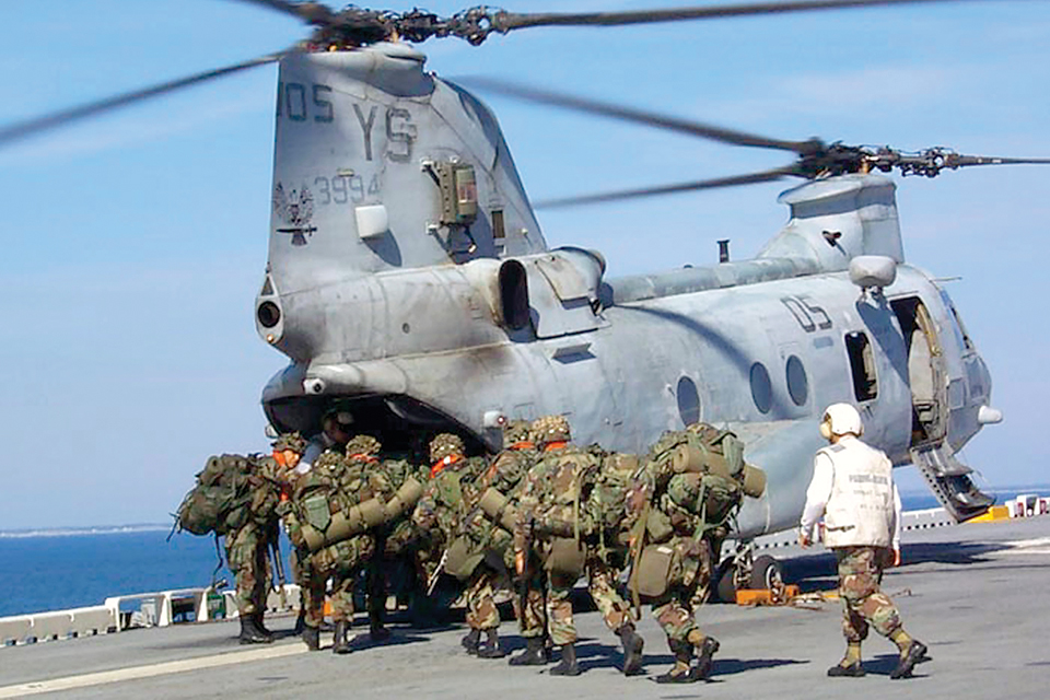 Members of the 22nd Marine Expeditionary Unit board a CH-46 during a beach-landing training exercise from USS Saipan in 2002. (U.S. Navy)