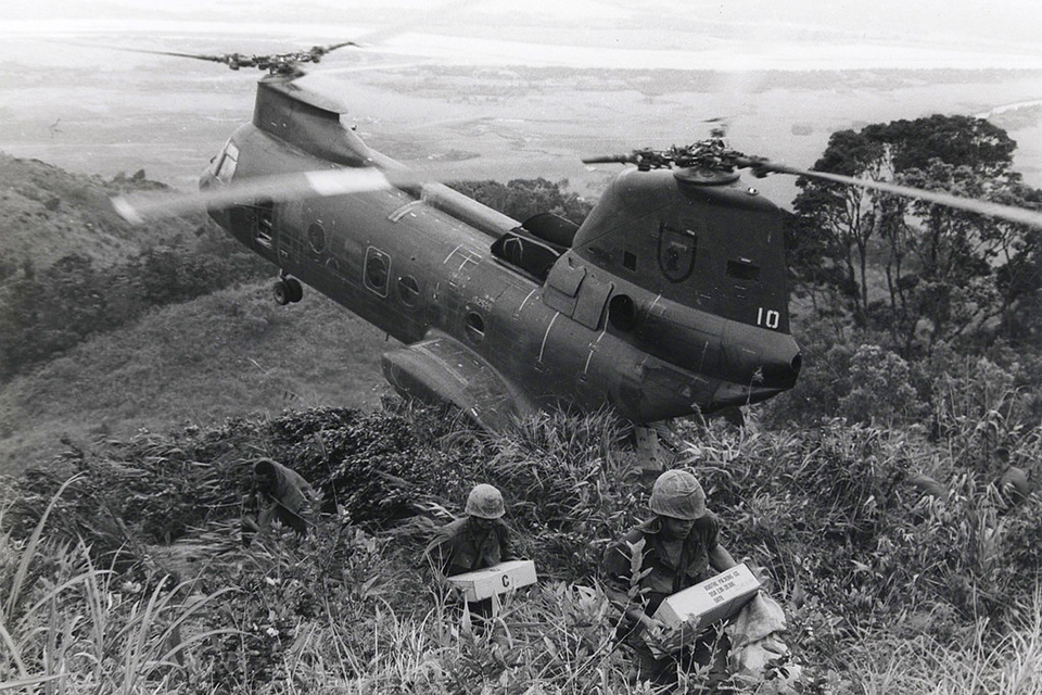 The Phrog was a primary source of transportation for the Marine Corps in Vietnam, transporting men and equipment in and out of tight spots. This CH-46 holds steady while Marines unload supplies from the rear ramp resting against a hillside in Vietnam. (U.S. Marine Corps)