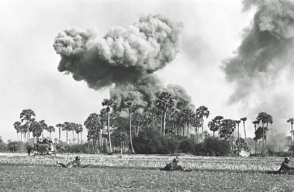 U.S. airstrikes hit enemy sites in the Parrot’s Beak border area on May 7, as South Vietnamese armored personnel carriers and rangers behind a rice paddy dike begin to advance.