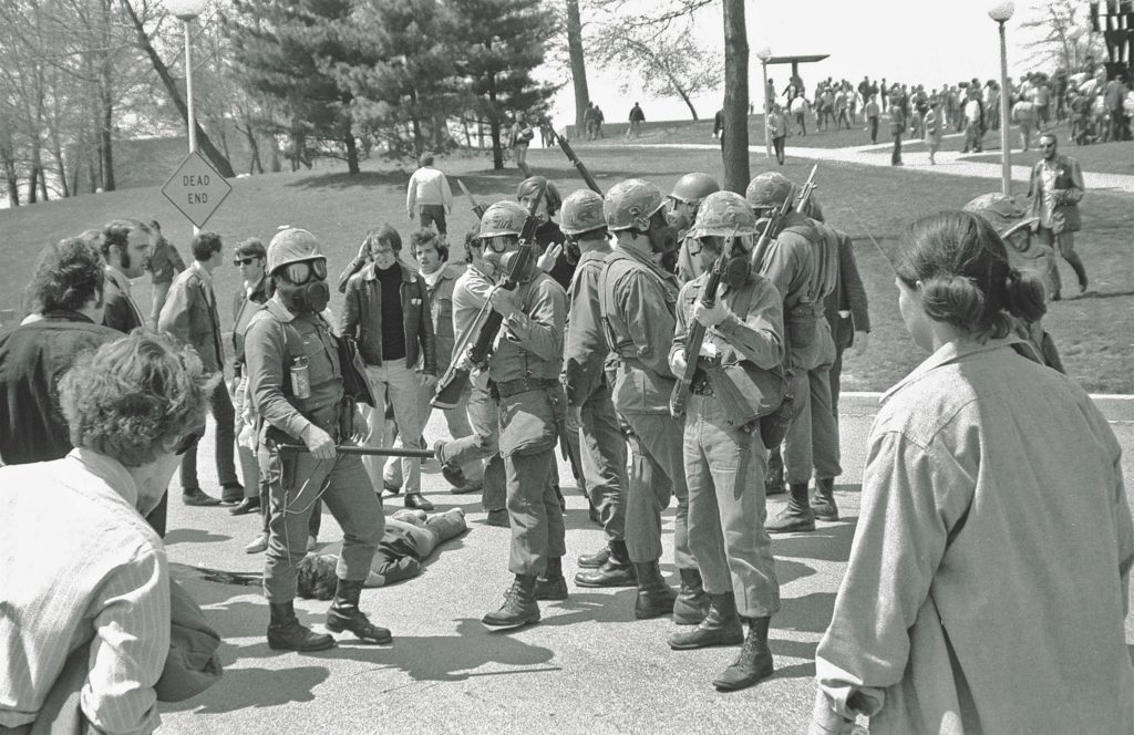 After the shooting, National Guard members are positioned near Jeffrey Miller’s body, while students gather around them. Fifty years later there are still debates over whether or not the guardsmen received an order to fire. (John Filo/Getty images)