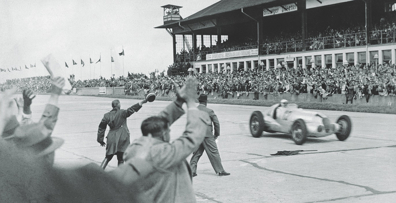 Caracciola crosses the finish line first in 1937. (Ullstein Bild/Getty Images)