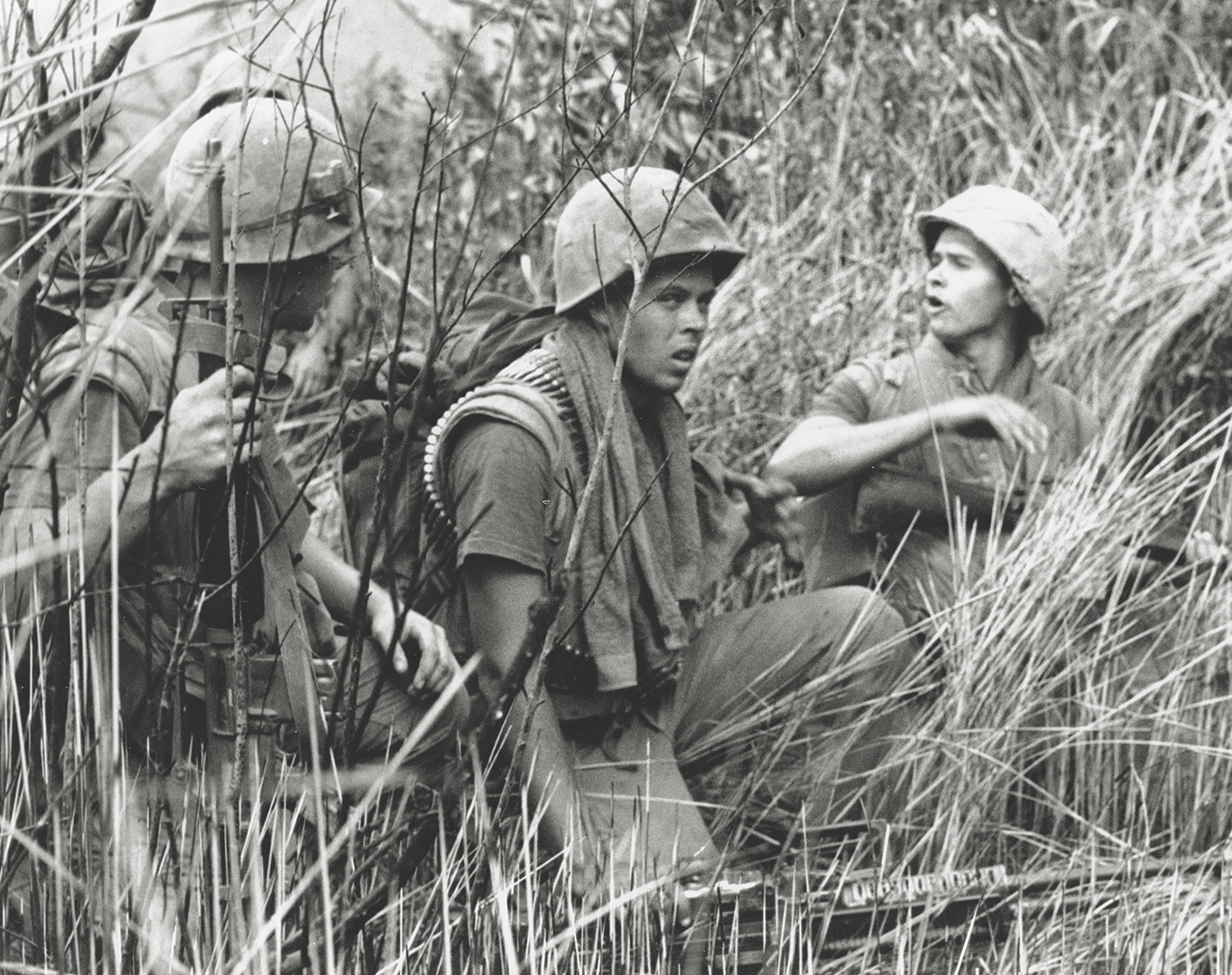 Near the DMZ on July 17, 1968, troops of Company E., 2nd Battalion, 3rd Marine Regiment, 3rd Marine Division, maneuver into position outside their landing zone. (USMC)