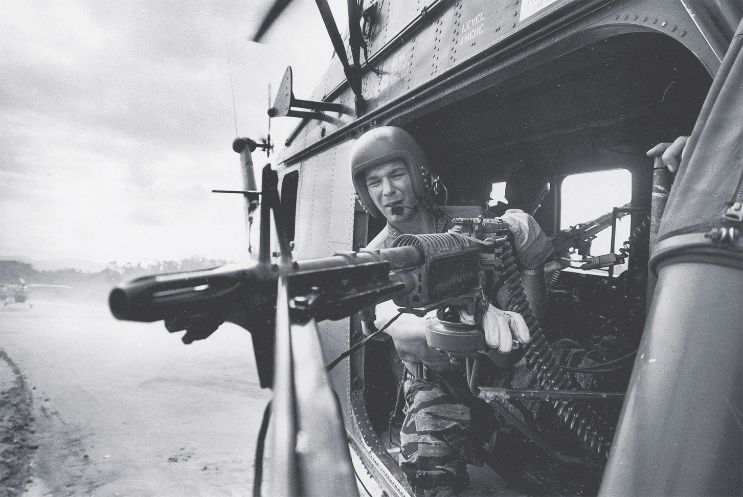 Marine Lance Cpl. James C. Farley fires an M60 machine gun from a helicopter near Da Nang on March 31, 1965. Larry Burrows/The Life Picture Collection via Getty Images.