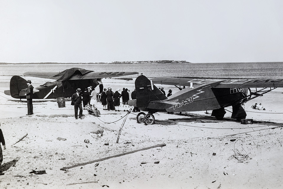 The French Yellow Bird (left), crewed by Armand Lotti, Jean Assollant and René Lefèvre, and American Green Flash, crewed by Roger Williams and Lewis Yancey, await low tide before their takeoff attempts. (Courtesy of the Lotti Family)