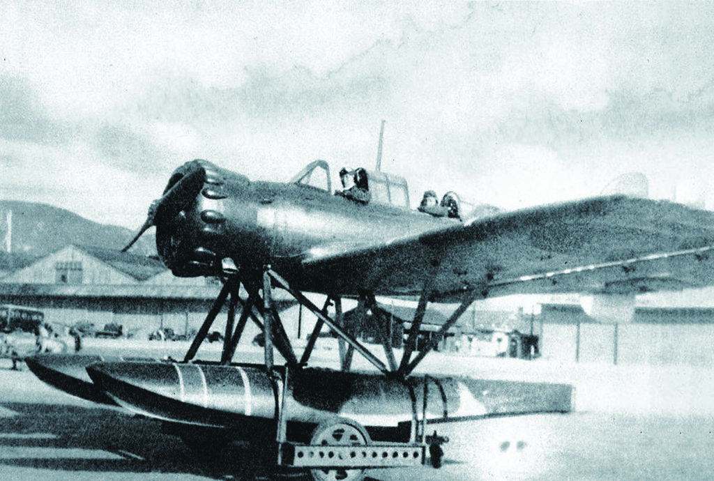 Fujita’s floatplane (above, at Yokosuka shipyards with Fujita and observer Shoji Okuda) was stored in sections in a hangar in front of the sub’s conning tower (here, sister ship I-26) and then assembled for flight (below). (National Archives)