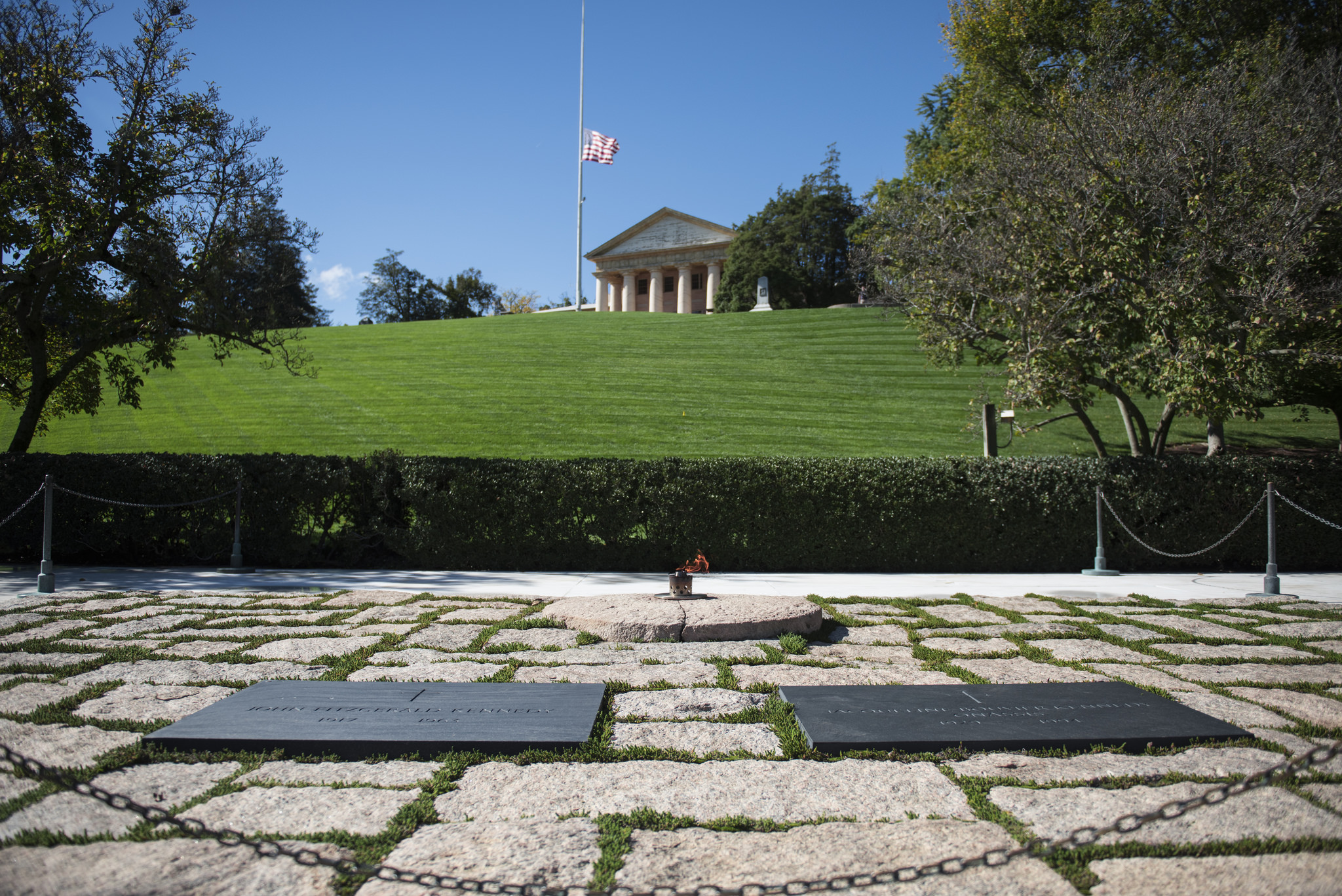 Per the ANC: During his visit to Arlington National Cemetery in 1963, President Kennedy had stood on the sloping hillside in front of Arlington House, which offers views of the Lincoln Memorial, Washington Monument and U.S. Capitol. "I could stay here forever," he told a park ranger. First Lady Jacqueline Kennedy wanted her husband's gravesite to be accessible to the American public…The chosen plot, on the hillside below Arlington House, is near where Kennedy had said he could stay "forever." 