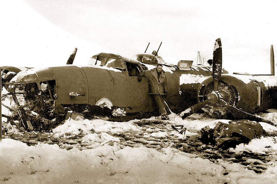Pilot Captain John Andrews stands beside his wrecked Liberator on Atka following his 1942 crash-landing. The crew of 40-2367 escaped with relatively minor injuries. (TM Spencer Collection/WOA)