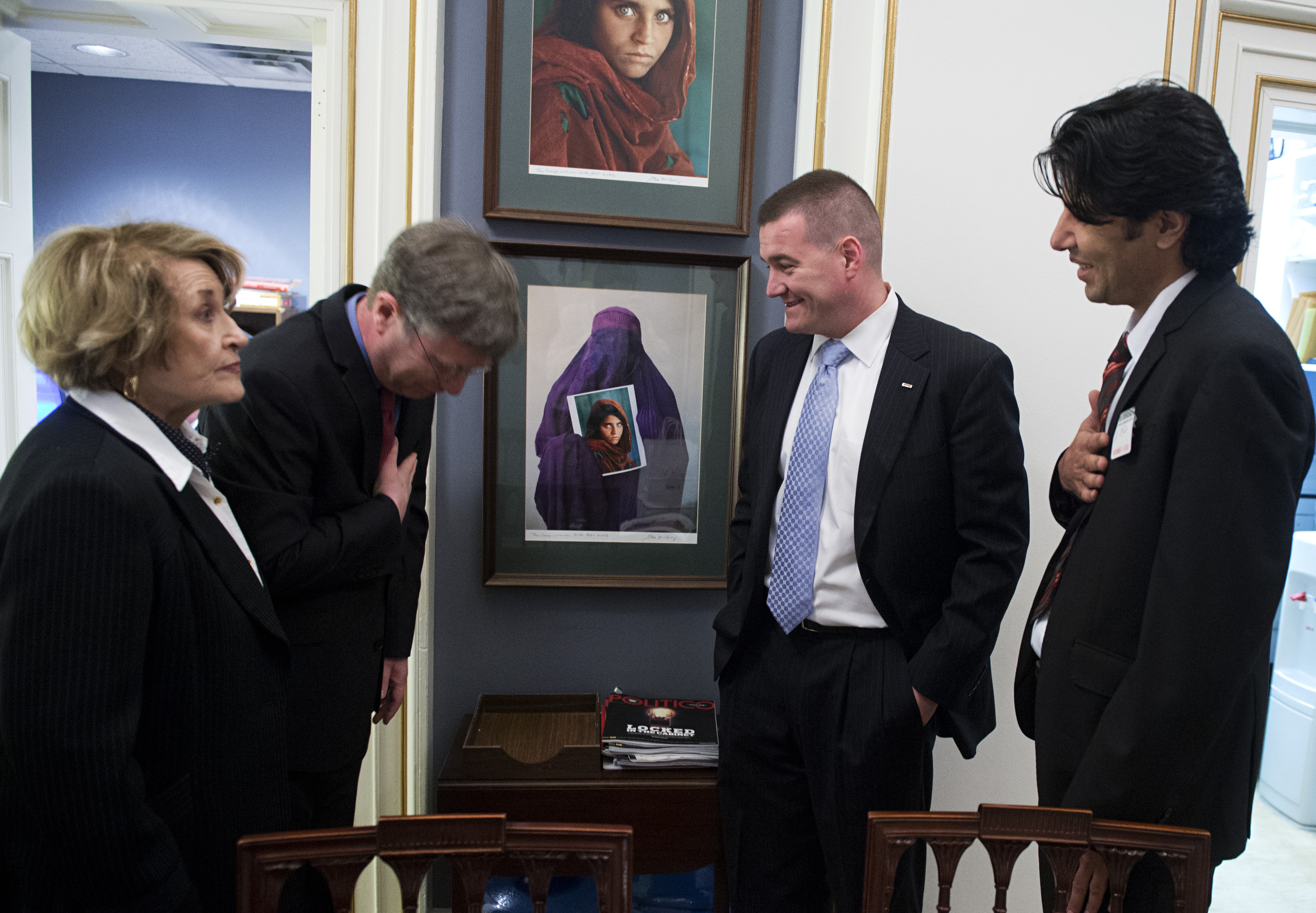 State Department Under Secretary Patrick Kennedy greets Shinwari in 2013, in the Capitol as Captain Zeller and Louise Slaughter, D-N.Y., look on. (Tom Williams/CQ Roll Call/Getty)