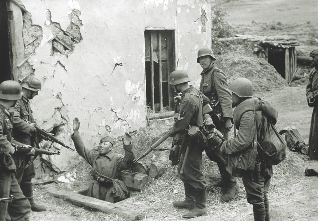 German soldiers hold an unarmed Russian soldier at gunpoint in 1942. Racial discrimination resulted in German troops killing unarmed soldiers and civilians during Operation Barbarossa. / Berliner Verlag via Getty Images