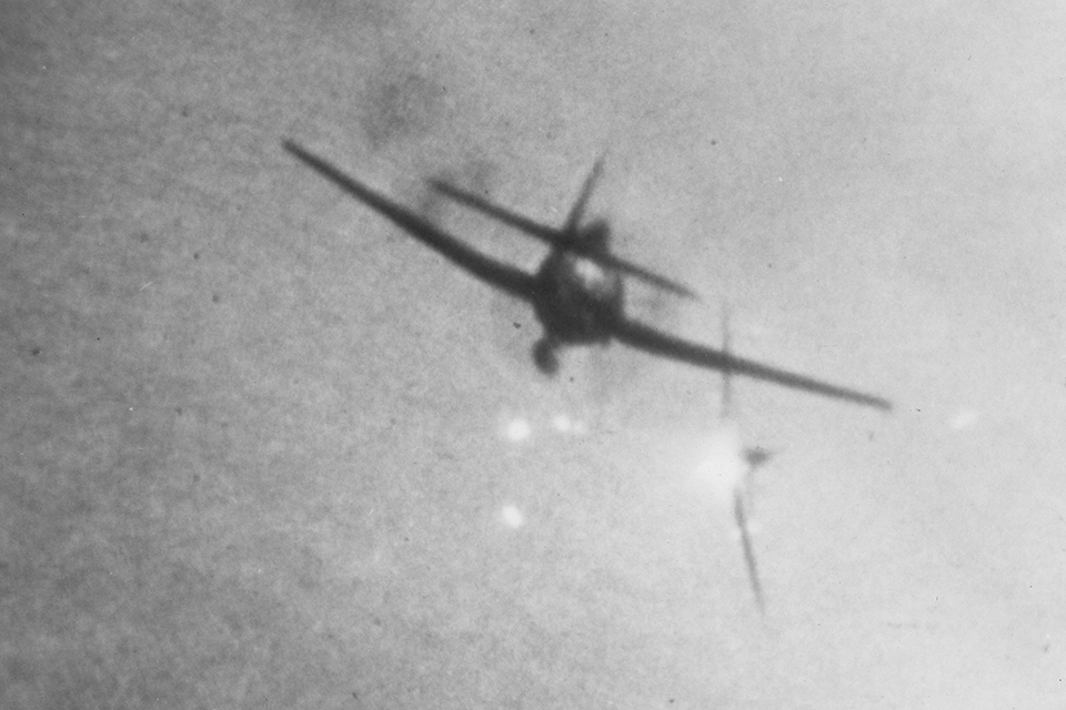 A Navy Grumman F6F Hellcat toting a drop tank shoots down a Mitsubishi A6M Zero. (National Archives)