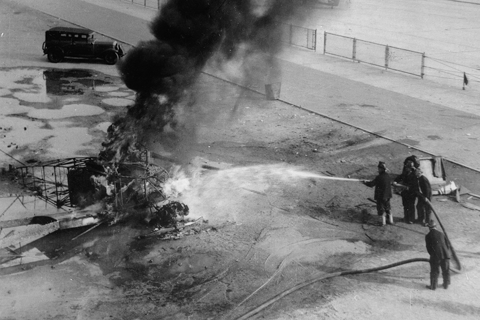 Firemen hose down the smoking wreckage of de Pinedo’s Bellanca after he crashed and was killed on takeoff from Floyd Bennett Field on September 3, 1933. (Imagno/Getty Images)