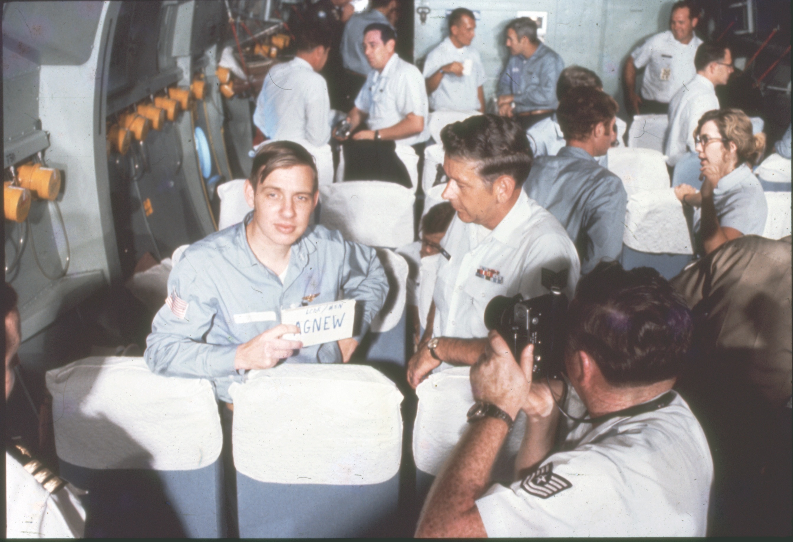 On a Starlifter flight carrying released POWs in March 1973, Navy Lt. Alfred Agnew displays his name. Agnew was captured Dec. 28, 1972. / U.S. Air Force