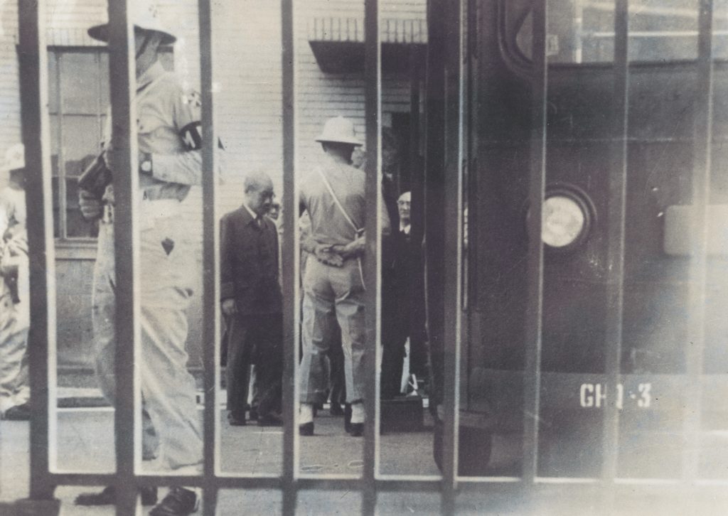 In a surreptitious photo taken by Case, guards escort General Hideki Tojo from his cell; he would be executed in late 1948. (Courtesy of Edgar W. Case)