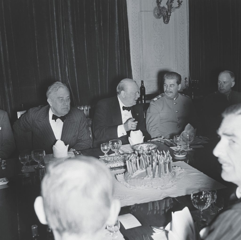 The “Big Three” gather for a high point of the conference: a dinner party at the British embassy to celebrate Churchill’s 69th birthday on November 30, 1943. (Imperial War Museums via Getty Images)