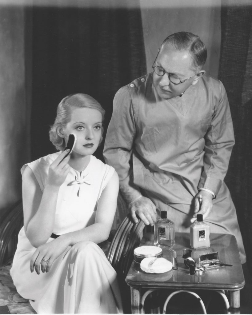 The company founded by makeup mogul Max Factor, here with actress Bette Davis, loaned its cosmetics workshops to the American war effort. (The Hollywood Museum)