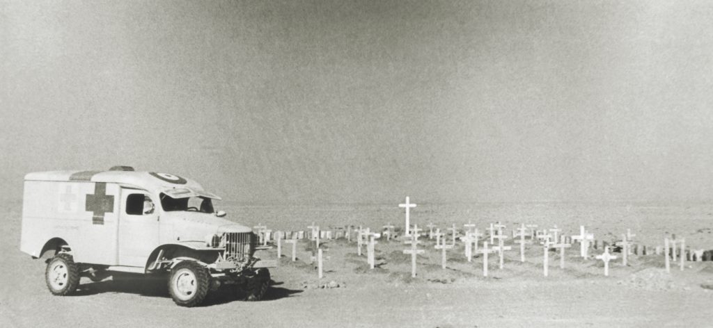 An AFS ambulance rests beside an Allied graveyard in the North African desert. During the war years, and across three theaters, there were 104 AFS volunteer casualties, 36 of them deaths. (AP Photo)