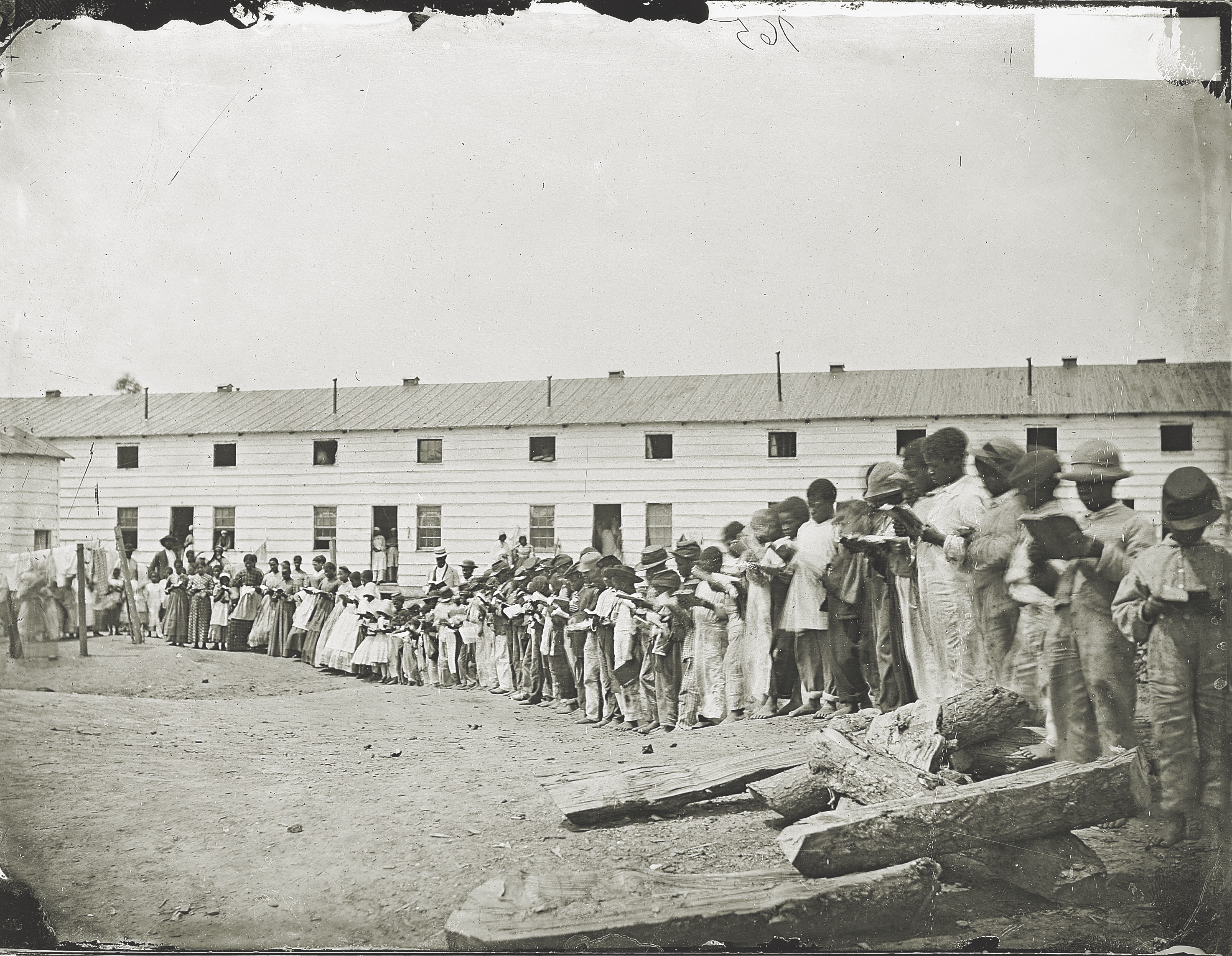 Recently freed children form a line as they read from textbooks at a camp for refugees near Washington, D.C. (National Archives)