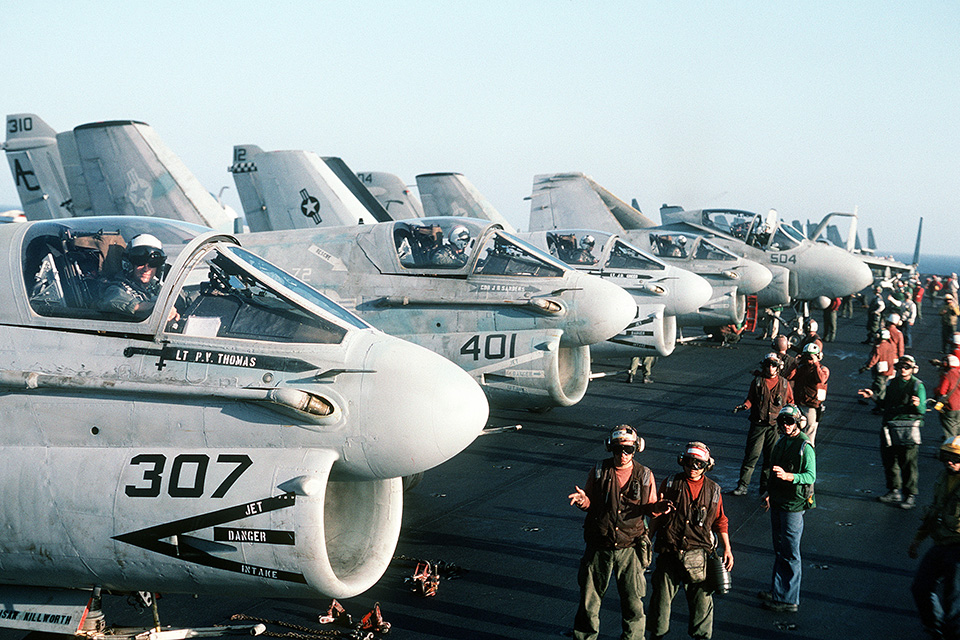 Corsair II pilots of VA-46 and VA-72 await takeoff as flight operations commence aboard USS John F. Kennedy during Operation Desert Shield, the Gulf War’s preliminary phase. (Lt. Cmdr. Dave Parsons/U.S. Navy)