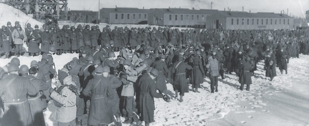 Hundreds of soldiers prepare to test their gas masks outside Camp Shanks’s three tear gas chambers. 