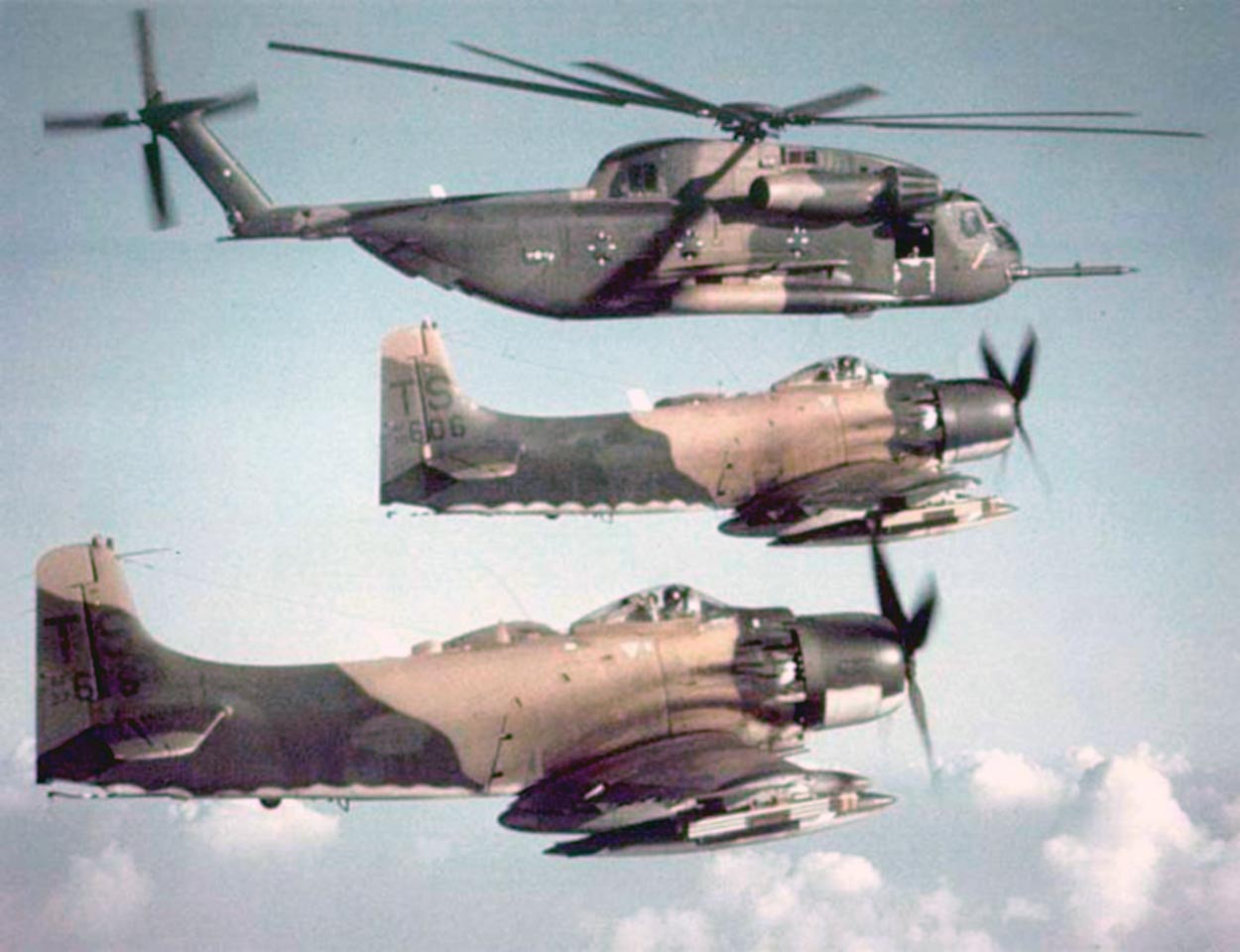 Five HH-53 Super Jolly Green Giant search and rescue helicopters, like the one shown at top in a formation with Air Force A-1 Skyraider attack aircraft, participated in the assault at Son Tay. 