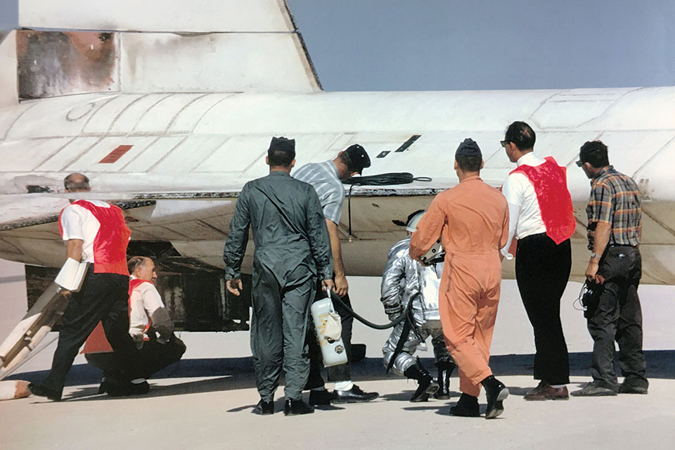 Knight, still wearing his pressure suit, and ground personnel examine damage to the X-15A-2 after his record flight. (NASA)