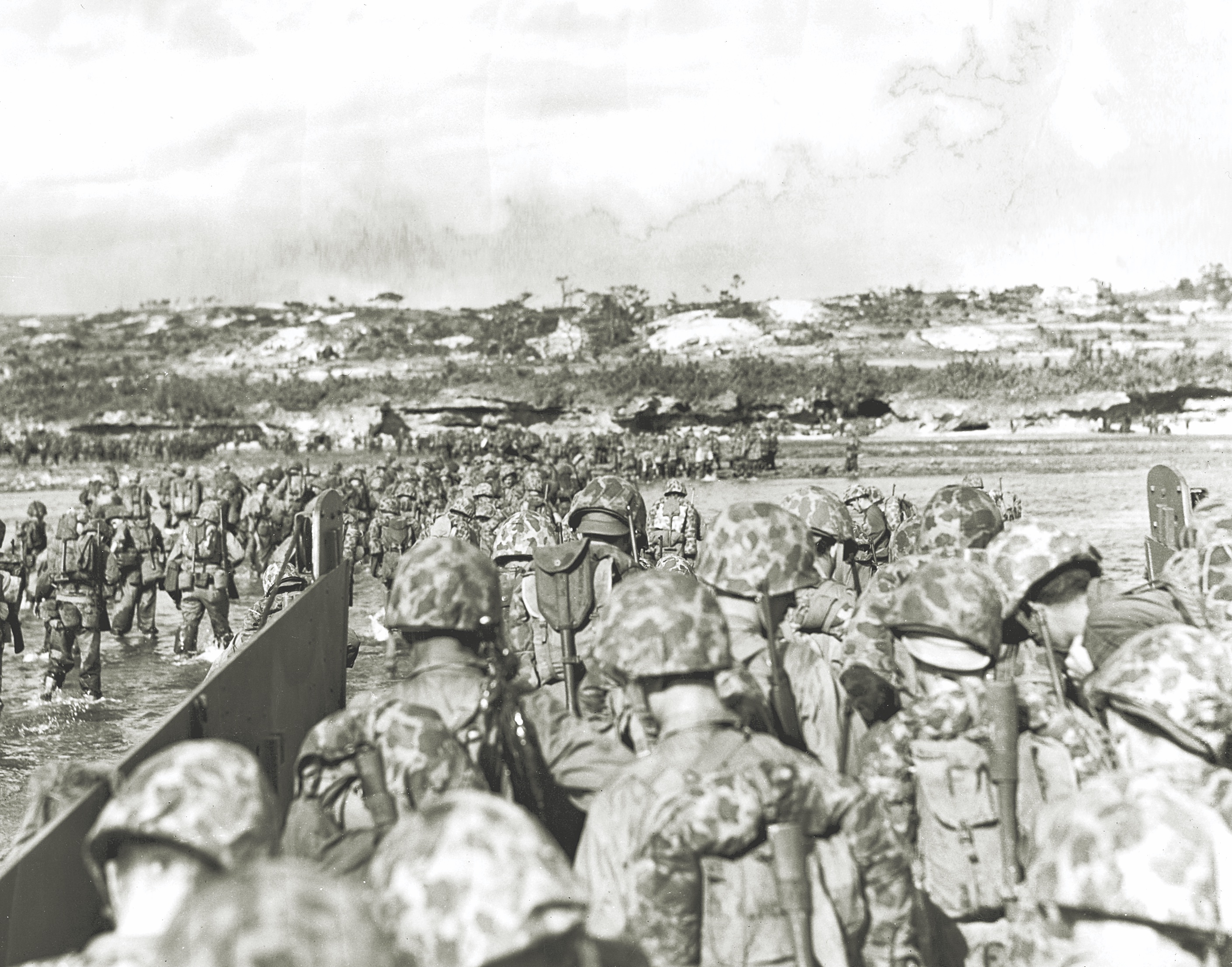 U.S. troops wade from landing craft onto the beaches of Okinawa on April 1, 1945. Pyle, who sailed to the island on the command ship USS Panamint, confided to friends, “I’m not coming back from this one.” (U.S. Marine Corps History Division)