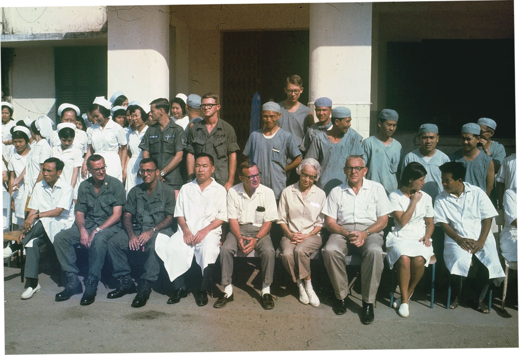 Kushner (front row, third from left) sits down for a photo with other members the Vinh Long medical team in the Military Provincial Health Assistance Program. Local Vietnamese team members included an X-ray technician, the head nurse and translators. / Courtesy of Sheldon Kushner