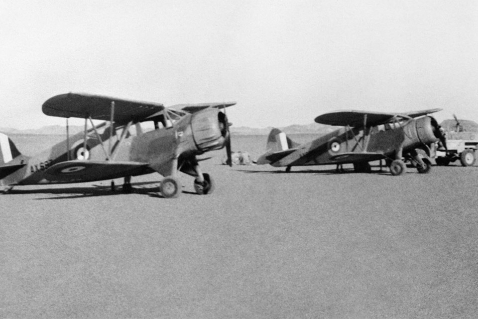Lt. Col. Guy Prendergast, the LRDG commander from 1941 to 1944, purchased two Waco biplanes for liaison, resupply and evacuating wounded. Here they wait in the Western Desert after delivering supplies to a patrol. (IWM HU 25081)