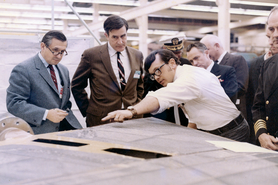 Mike Pelehach (left), the father of the Tomcat, and fellow Grumman engineers look over the first F-14 during its construction. (Cradle of Aviation Museum)