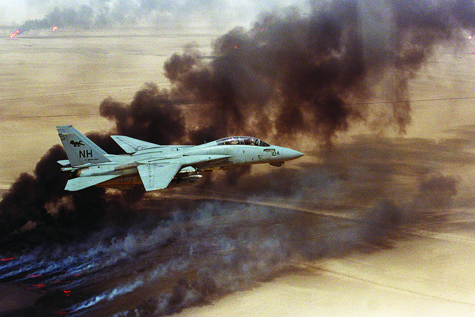 In the aftermath of Operation Desert Storm, an F-14A from VF-114 flies over oil well fires in Kuwait in August 1991. (U.S. Navy)