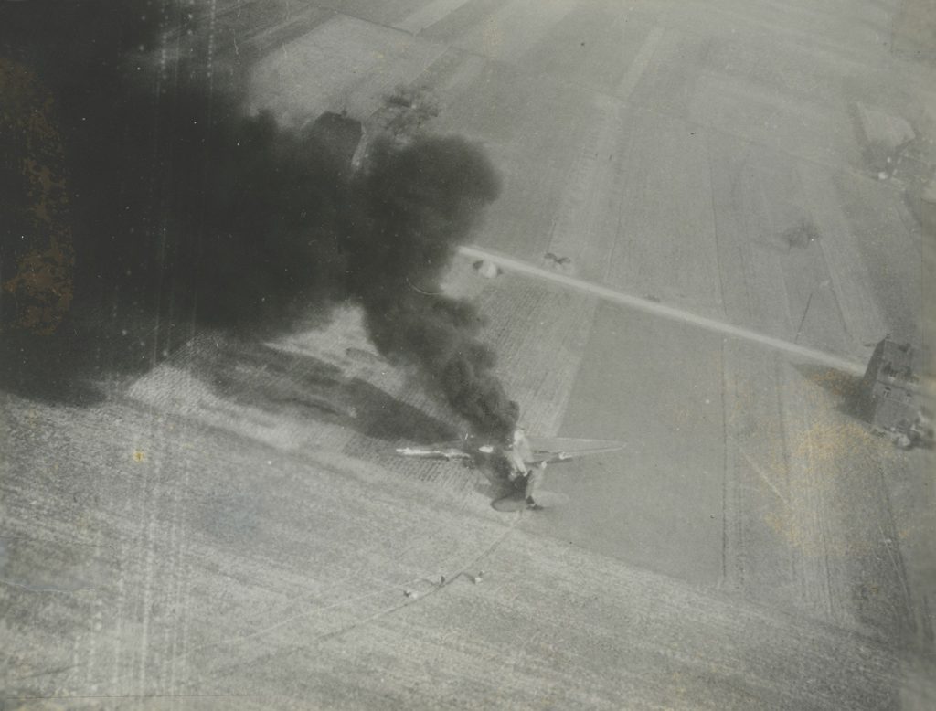 A downed C-47 burns (here, in Holland). The incident over Sicily caused the loss of 23 such planes, with another 37 greatly damaged. (National Archives)