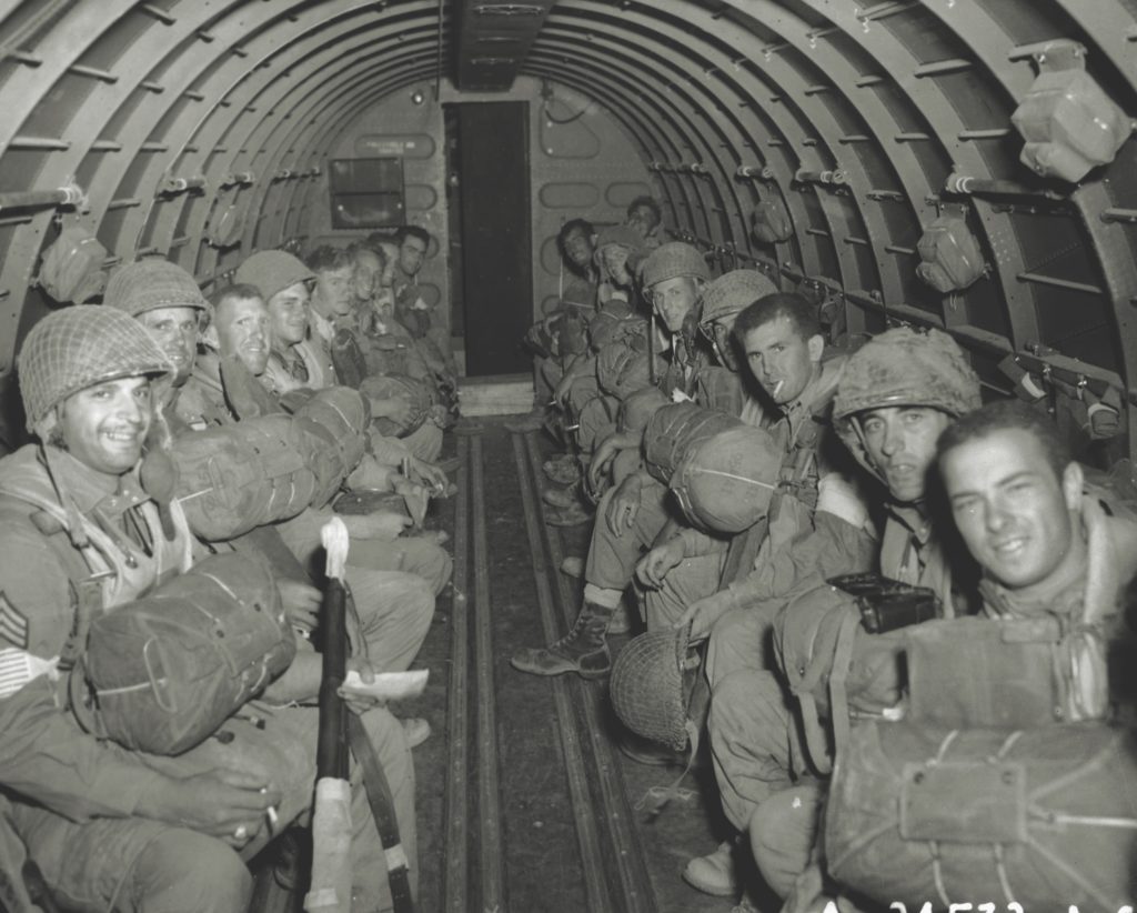 En route to Sicily, paratroopers of the 504th Regimental Combat Team appear relaxed, anticipating a relatively problem-free flight as they move in to reinforce another unit that had jumped the night before. (US Air Force/Getty Images)