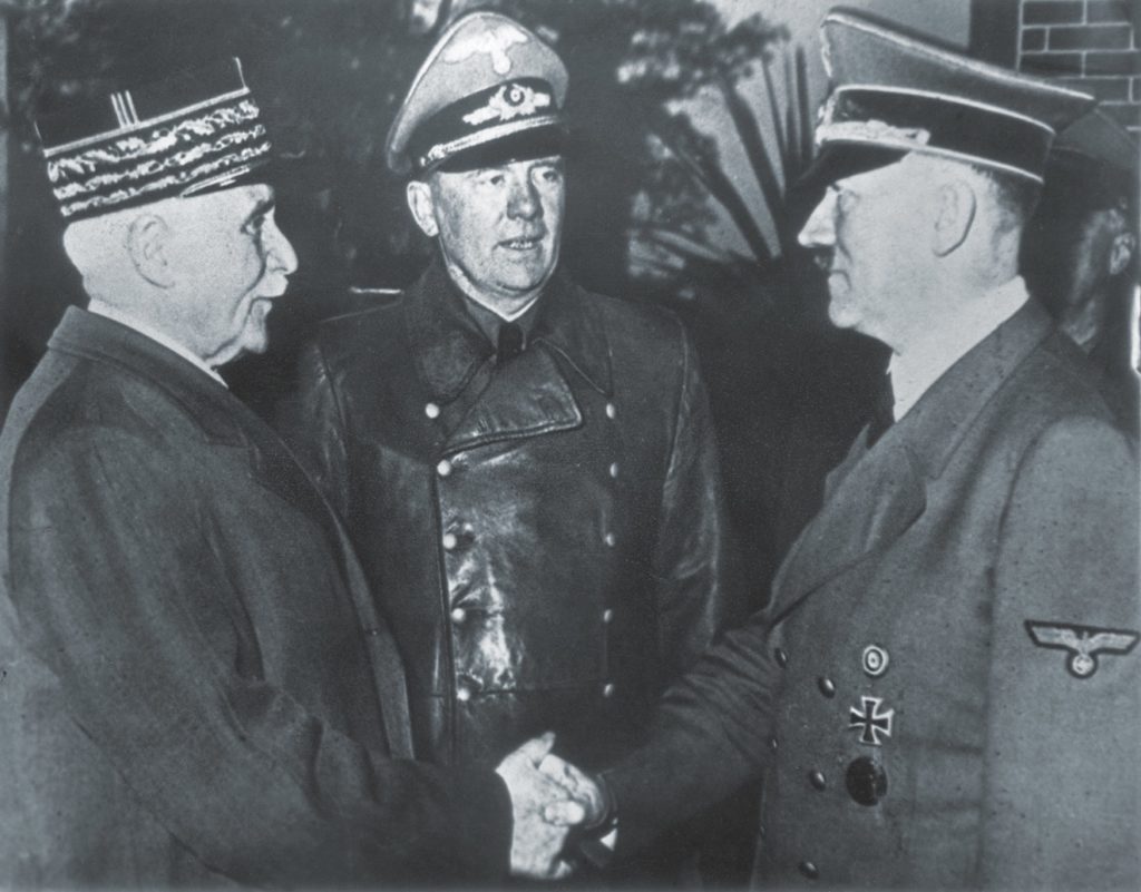 Pétain famously shook hands with Adolf Hitler on October 24, 1940 (above), signaling the beginning of the Vichy era of cooperation and collaboration with the Germans. While some embraced it, like these young French SS  recruits departing for their garrison (below), a growing number of others opted to resist the occupiers. (Hulton Archive/Getty Images)