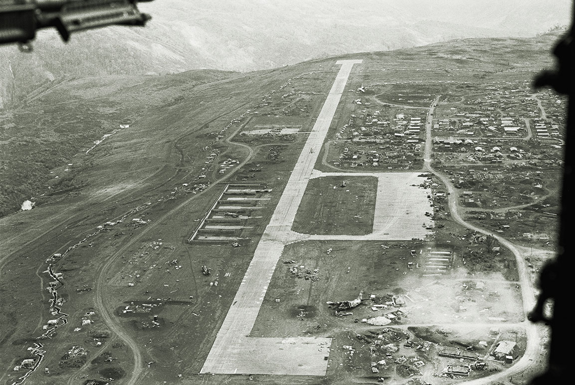 The airstrip at Khe Sanh, below right, is littered with aircraft that were destroyed by enemy fire. / Getty Images