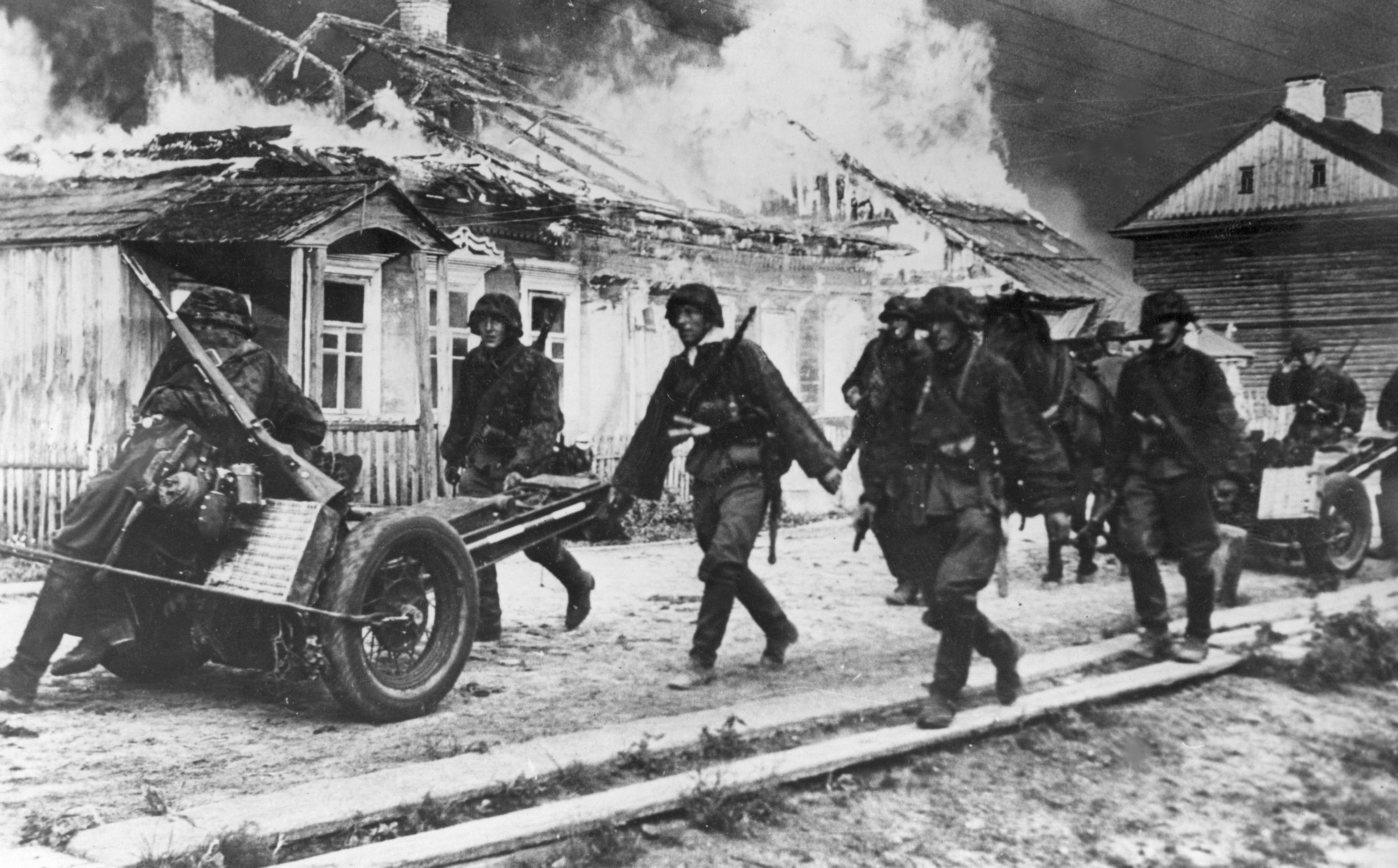 A Waffen-SS unit burns a village while advancing on the Eastern Front, c. 1941 / Polish State Archive