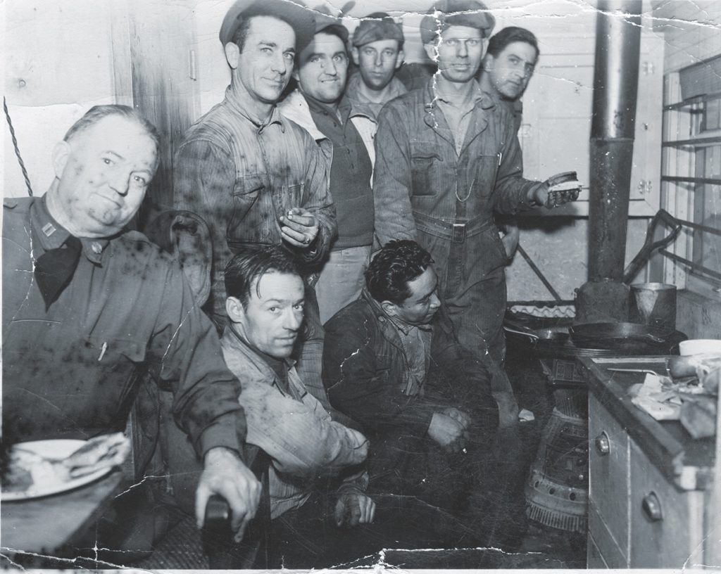 A group of military railroaders enjoys the warmth of their small kitchen in Skagway. (Courtesy of Jerry Latham) 