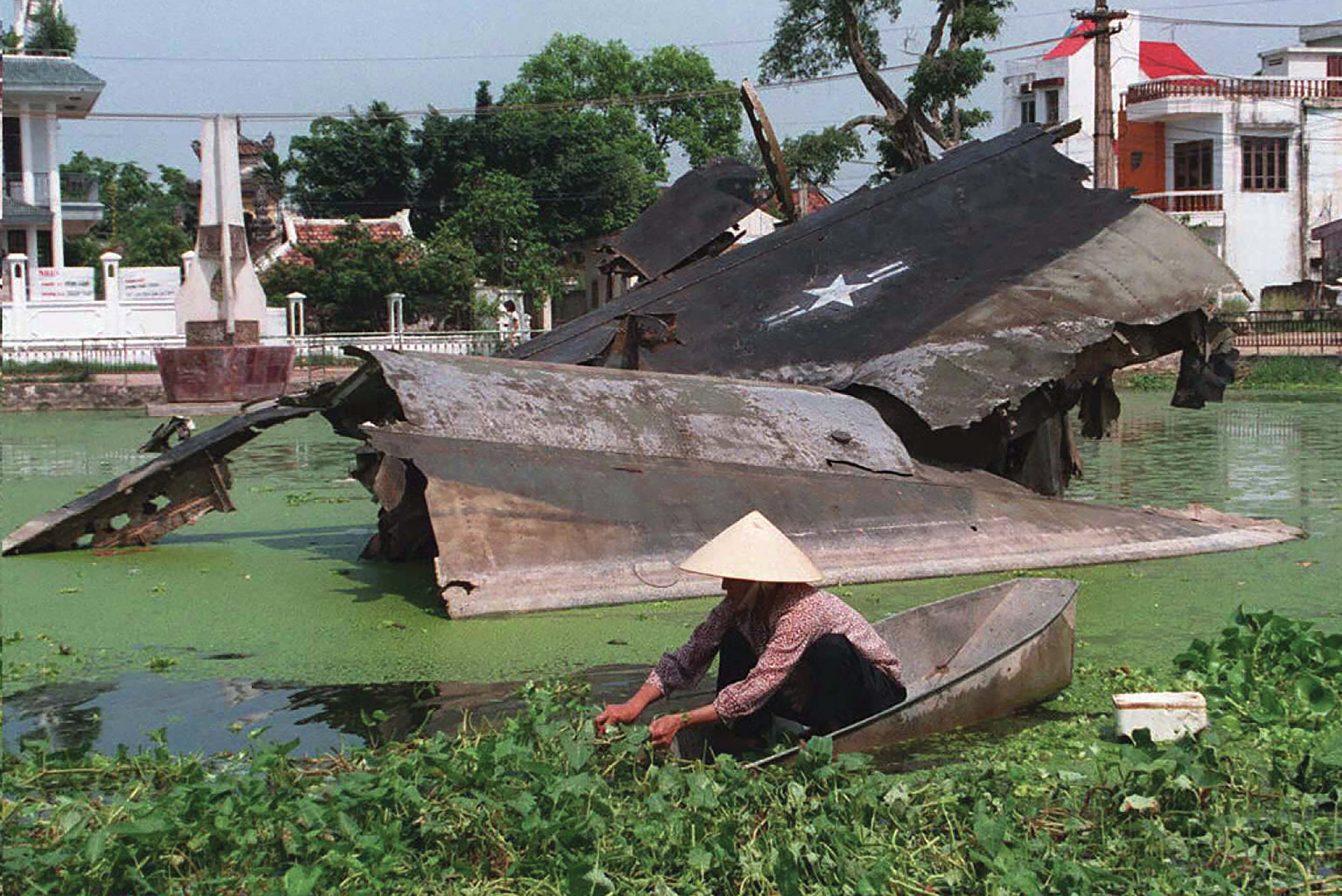 The remains of a B-52 bomber shot down in 1972 rest in a small lake in the Ngoc Ha village of Hanoi. / Getty Images