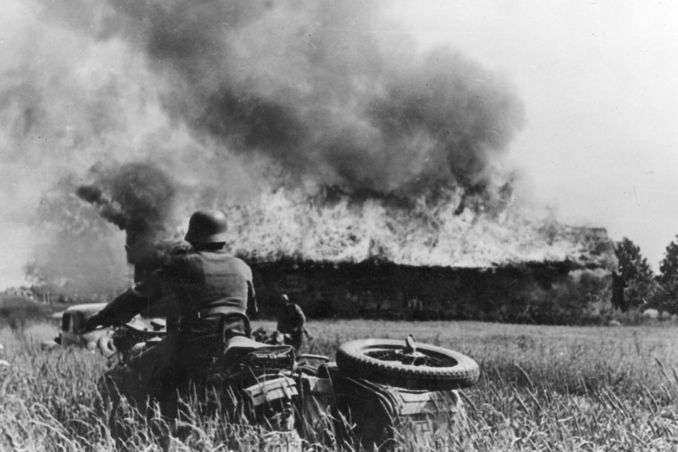 A German soldier watches a structure burn on the Eastern Front. Steinmeier recalled atrocities committed during Operation Barbarossa, Germany's invasion of the Soviet Union. / Polish State Archive